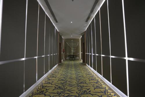 a hallway with a yellow and black patterned floor at Dar Hashim Al Nuzha Serviced Apartments - Economic in Riyadh