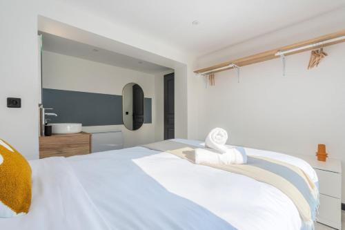 a bedroom with a white bed and a sink at House 4bed 2bath with garden and private parking. in La Madeleine