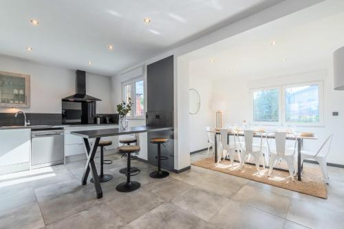 a kitchen with a dining room table and chairs at House 4bed 2bath with garden and private parking. in La Madeleine