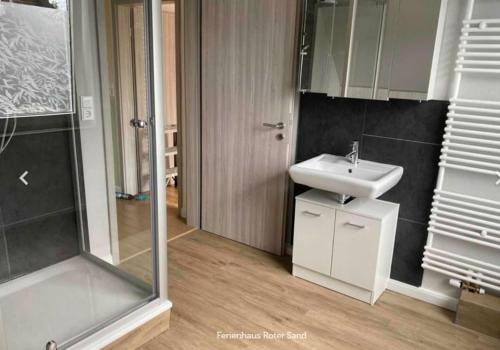 a bathroom with a sink and a shower at Haus Roter Sand in Hooksiel in Wangerland