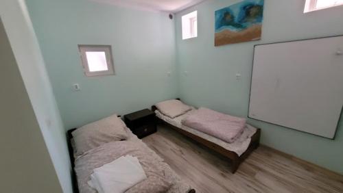 Zimmer mit 2 Betten und einer weißen Wand in der Unterkunft Leniuszek in Stronie Śląskie