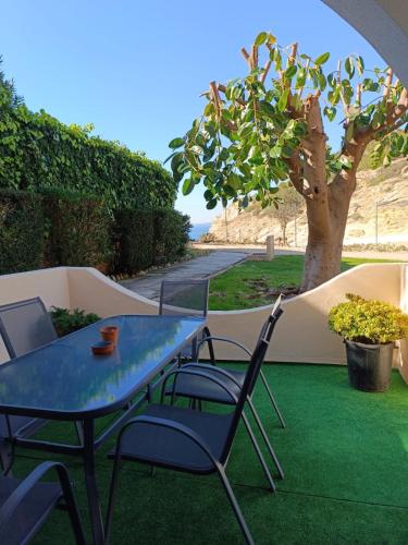 a blue table and chairs on a green lawn at Jardim de Mar in Carvoeiro