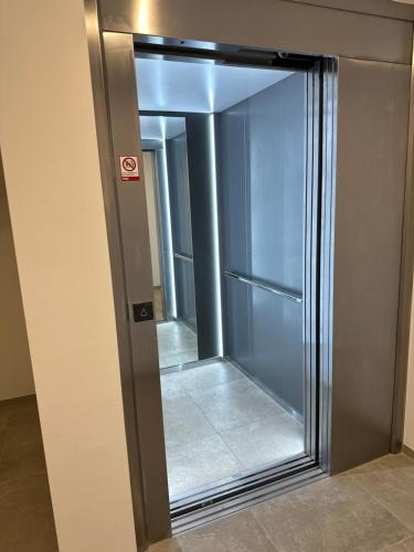 a sliding glass door with a mirror in a room at Ferienwohnung Amalie in Füssen