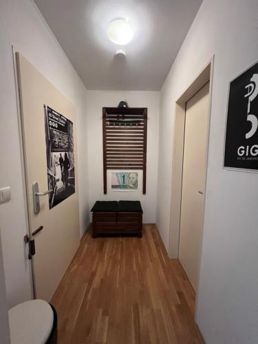 a room with a hallway with a window and a bench at Mini Loft Apartment in Garmisch-Partenkirchen