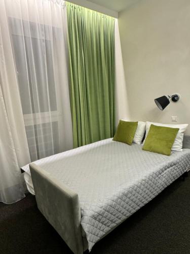 a bedroom with a large bed with green curtains at The best in Dresden
