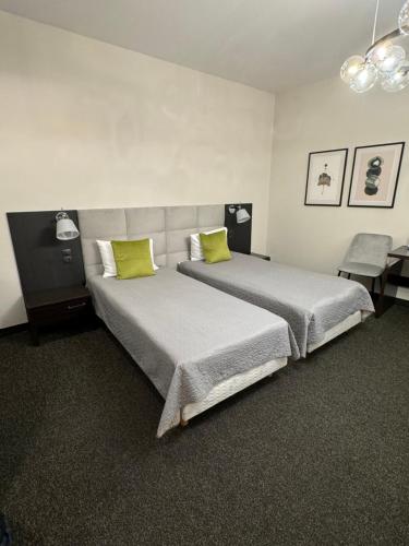 a bedroom with two beds with lime green pillows at The best in Dresden