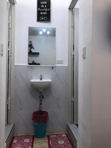 a bathroom with a sink and a mirror at Hope Inn in Bolod