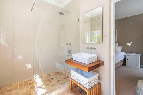 a bathroom with a sink and a shower at 2 Bedroom Apartment With Amazing City Views in Cape Town