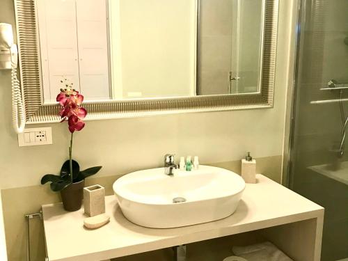 a bathroom with a white sink and a mirror at ESMERALDA'S ROOMS in Porto San Paolo