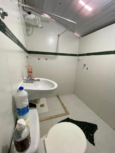 a bathroom with a toilet and a sink at Apartamento temporada carnaval in Salvador