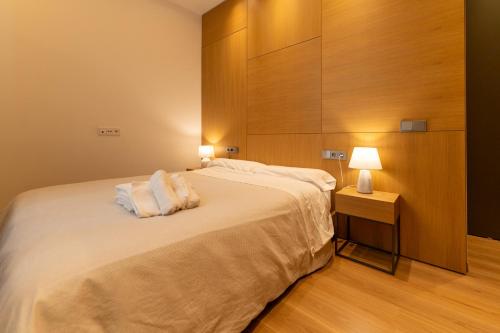 a bedroom with a large bed with two pillows on it at Tendillas Plaza in Córdoba