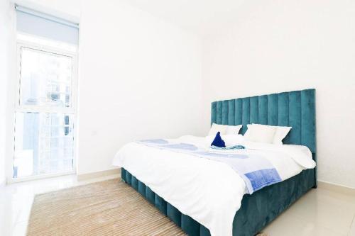 1 dormitorio con 1 cama grande y cabecero verde en 1BR Luxury Apartment close to JBR Beach Marina, en Dubái