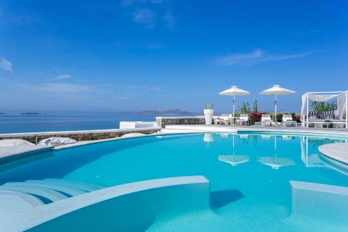 a swimming pool with a view of the ocean at DeLight Boutique Hotel - Small Luxury Hotels of the World in Agios Ioannis Mykonos