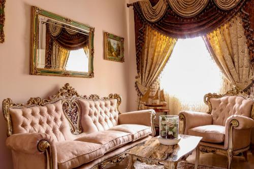 a living room with two couches and a table at Madonnina Homestay in St Julian's