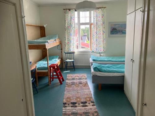 a room with two bunk beds and a window at STF Tre Björnar B&B in Älvdalen