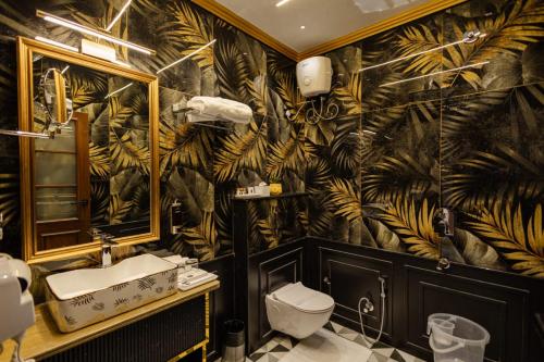 a bathroom with a sink and a banana wallpaper at Dream Connect Boutique House in Jodhpur