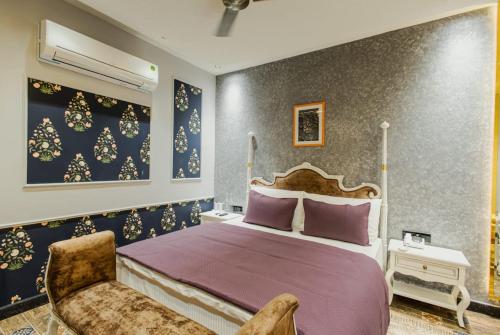 a bedroom with a large bed and a chair at Dream Connect Boutique House in Jodhpur