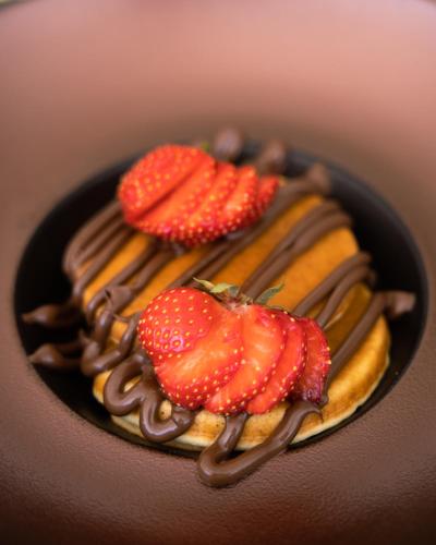 a chocolate dessert with strawberries on top of it at DeLight Boutique Hotel - Small Luxury Hotels of the World in Agios Ioannis Mykonos