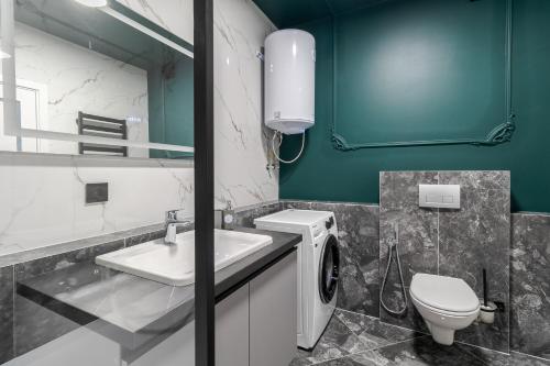 a bathroom with a sink and a washing machine at 77 views apartments by INSHI in Lviv