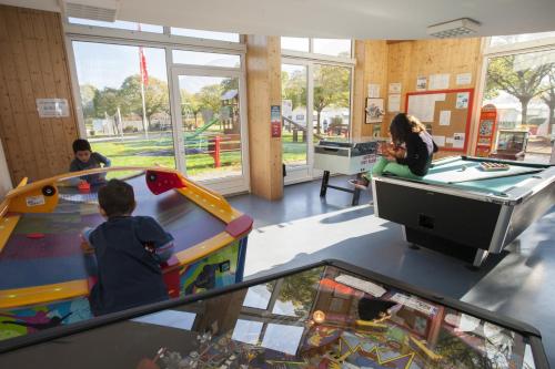 a woman and two children playing in a play room at Relais de la Sarvaz in Saillon