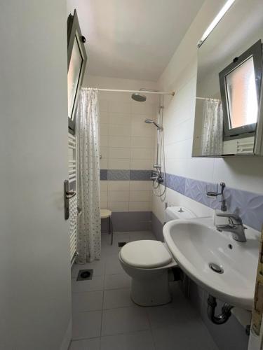 a bathroom with a toilet and a sink at Villa Alkionis in Skala