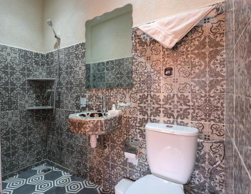 a bathroom with a toilet and a sink at Tamatert Guest House in Imlil