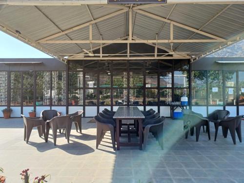 a room with tables and chairs in a building at Shivir Aranya - Wilderness Resort in Alwar