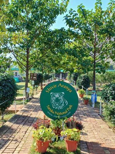 a sign for a garden in a park at Shivir Aranya - Wilderness Resort in Alwar