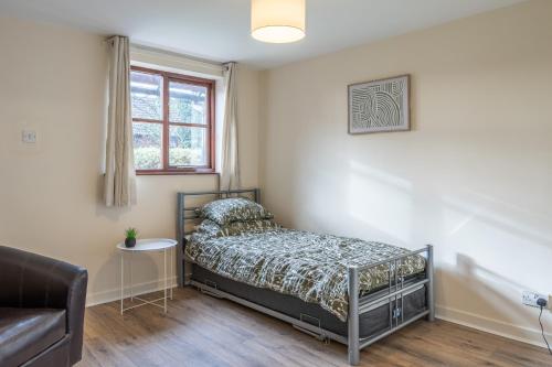 a bedroom with a bed and a window at Modern studio flat in Wellington, Telford in Wellington