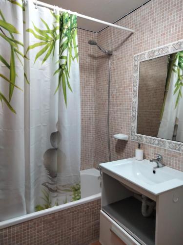 a bathroom with a sink and a shower curtain at Cala´n Bosch in Cala en Bosc