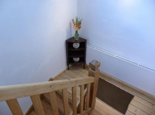 a stairway with a vase of flowers on a table at Landhaus Semmering in Semmering