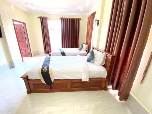 a bedroom with a large bed in a room at Asia Ready Travel & Tours Siem Reap in Siem Reap