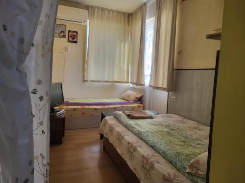 a small room with two beds and a window at East Gate Guest Rooms in Plovdiv