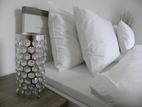 a vase sitting on a table with white pillows at Landhaus Semmering in Semmering