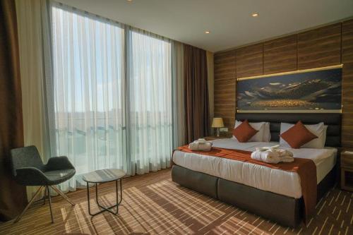 a hotel room with a bed and a large window at Ekor Elegance Hotel in Famagusta