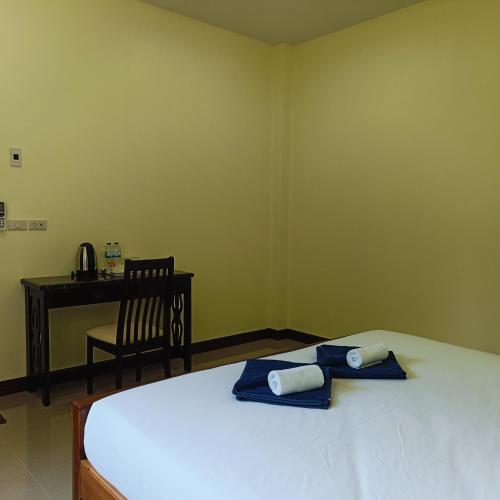 a bedroom with a bed with two towels on it at Khao Sok Green Garden Resort in Khao Sok