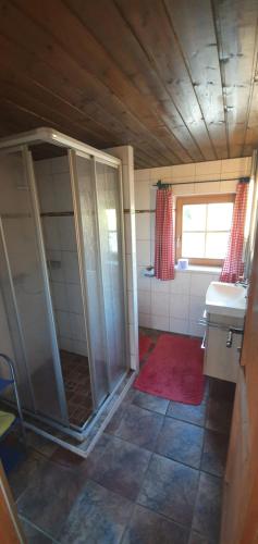 a bathroom with a shower and a sink at Talblickhütte in Rauris