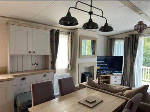 a kitchen and dining room with a table and chairs at Orchard View Caravan in Boston
