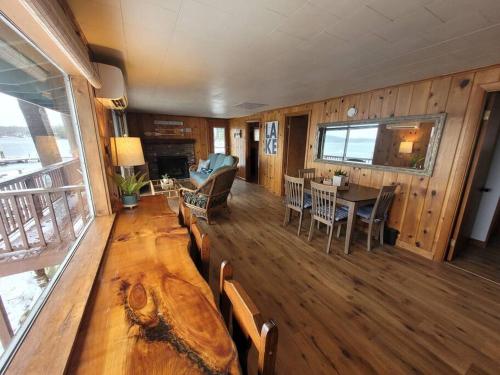 a living room with a table and a dining room at Winnipesaukee Lakefront w/ Dock in Laconia