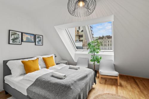 a bedroom with a bed and a large window at Modern Haven - Near Klinik Floridsdorf in Vienna