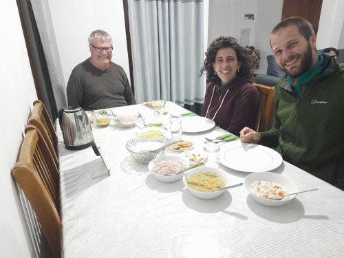 a group of people sitting at a table eating food at Green Villa in Nuwara Eliya