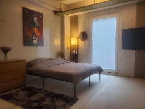 a bedroom with a bed and a large window at SPA industrial Loft in einem ehemaligen Umspannwerk in Essen