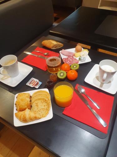 a table with a breakfast of bread and eggs and coffee at EtC...Hôtel - Strasbourg Hyper Centre in Strasbourg
