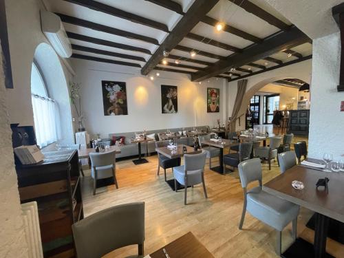 a restaurant with tables and chairs in a room at Logis Hôtel de France & Restaurant Pamiers in Pamiers