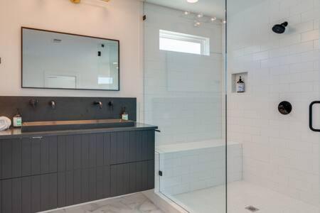 a bathroom with a shower with a glass door at The Alessia - Downtown Luxury in Gated Community in Nashville