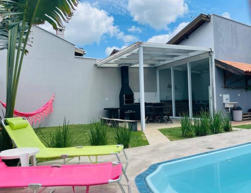 a patio with a pool and a house at Casa com Piscina e ótimo custo benefício!! in Brotas