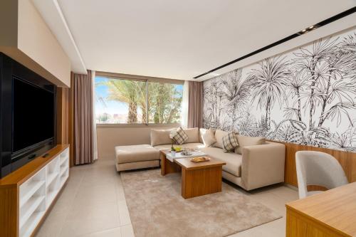 a living room with a couch and a tv at Kenzi Rissani in Er Rachidia