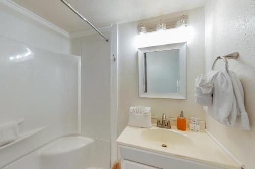 a white bathroom with a sink and a shower at The Sea Glass Cottage in Ocean Park