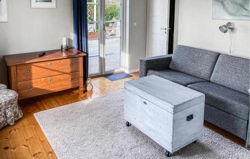 a living room with a couch and a table at Lovely Home In Munka-Ljungby With Wifi in Munka-Ljungby