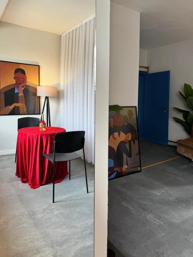 a room with a table with a red table cloth at Etern Stays - PRN Apartment in Pristina